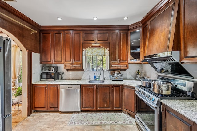 38-16 220th St, Bayside, NY 11361 - kitchen featuring appliances with stainless steel finishes, decorative backsplash, light stone countertops, arched walkways, and recessed lighting