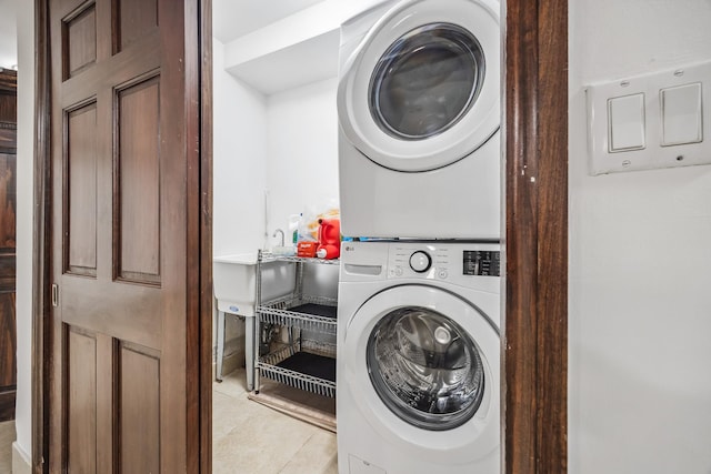 38-16 220th St, Bayside, NY 11361 - laundry area with stacked washer / drying machine and light tile patterned flooring