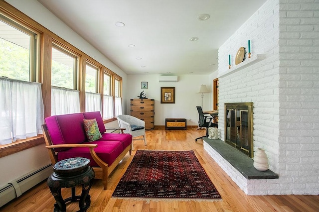 4 Mary Ann Ave, Saugerties, NY 12477 - living room featuring baseboard heating, wood finished floors, a fireplace, a wall mounted AC, and recessed lighting