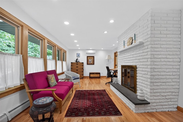 4 Mary Ann Ave, Saugerties, NY 12477 - living area with a baseboard heating unit, a wall unit AC, a fireplace, wood finished floors, and recessed lighting