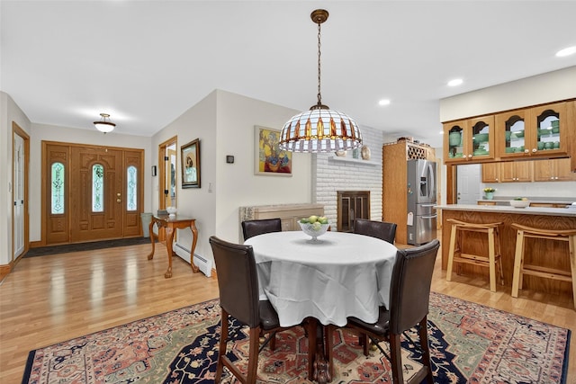 4 Mary Ann Ave, Saugerties, NY 12477 - dining space with a baseboard radiator, light wood-type flooring, a fireplace, and recessed lighting