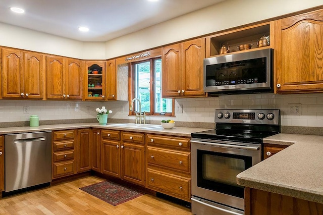 4 Mary Ann Ave, Saugerties, NY 12477 - kitchen featuring appliances with stainless steel finishes, brown cabinets, light wood finished floors, light countertops, and recessed lighting