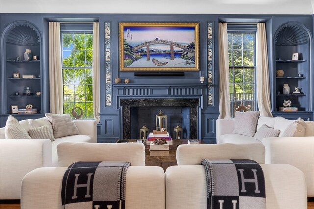 103 Albany Ave, Kingston, NY 12401 - living room featuring built in features, a premium fireplace, and wood finished floors