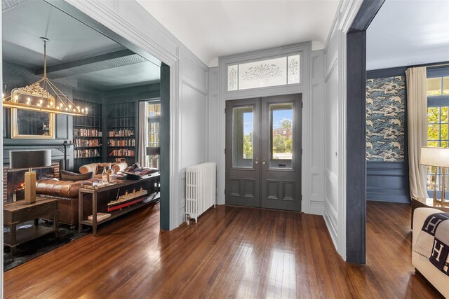 103 Albany Ave, Kingston, NY 12401 - entryway with radiator, a decorative wall, french doors, hardwood / wood-style flooring, and a chandelier