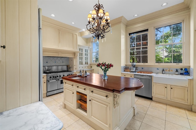 103 Albany Ave, Kingston, NY 12401 - kitchen featuring stainless steel appliances, wood counters, ornamental molding, light tile patterned floors, and a chandelier