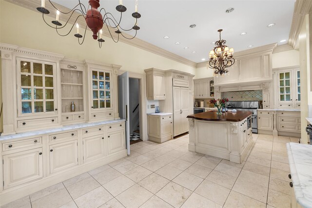 103 Albany Ave, Kingston, NY 12401 - kitchen featuring a chandelier, stainless steel range, tasteful backsplash, ornamental molding, and glass insert cabinets