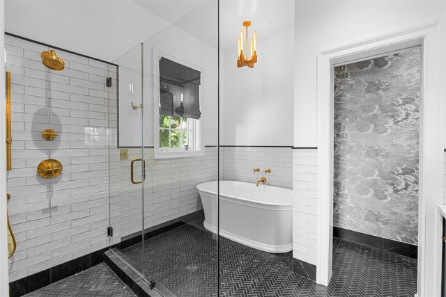 103 Albany Ave, Kingston, NY 12401 - bathroom with a soaking tub, a stall shower, wallpapered walls, and a wainscoted wall