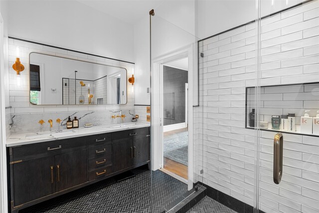 103 Albany Ave, Kingston, NY 12401 - full bathroom with double vanity, tile patterned flooring, and tile walls