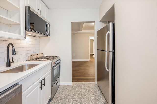 142 E 49th St Unit 4C, New York Manhattan, NY 10017 - kitchen featuring stainless steel appliances, backsplash, white cabinets, and light countertops