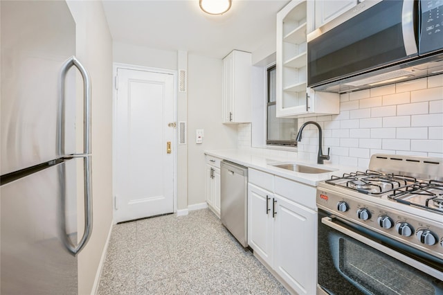142 E 49th St Unit 4C, New York Manhattan, NY 10017 - kitchen featuring stainless steel appliances, tasteful backsplash, white cabinets, and light countertops