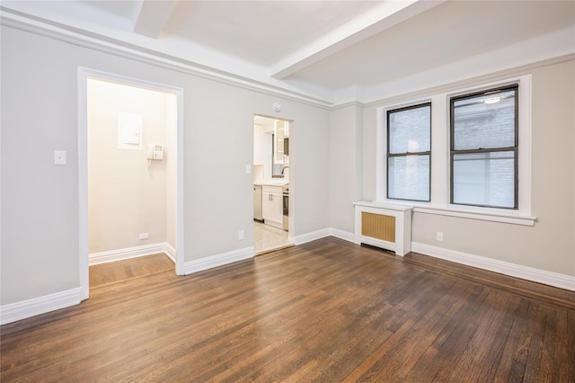 142 E 49th St Unit 4C, New York Manhattan, NY 10017 - unfurnished room with radiator, dark wood-style floors, and beam ceiling