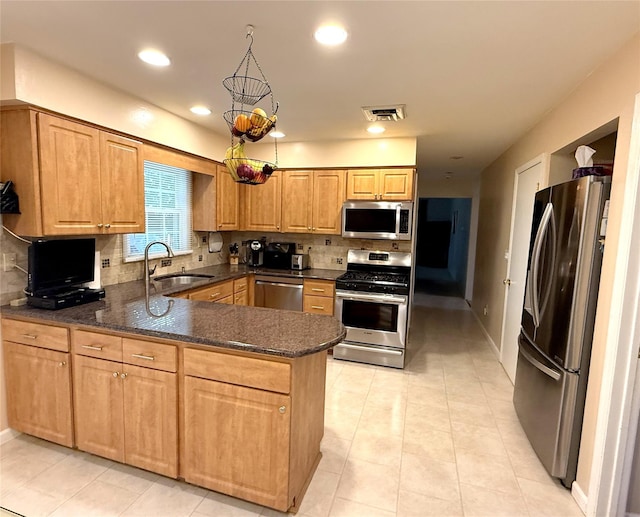 7 Maplewood Ln, New City, NY 10956 - kitchen with appliances with stainless steel finishes, a peninsula, decorative backsplash, light tile patterned flooring, and recessed lighting