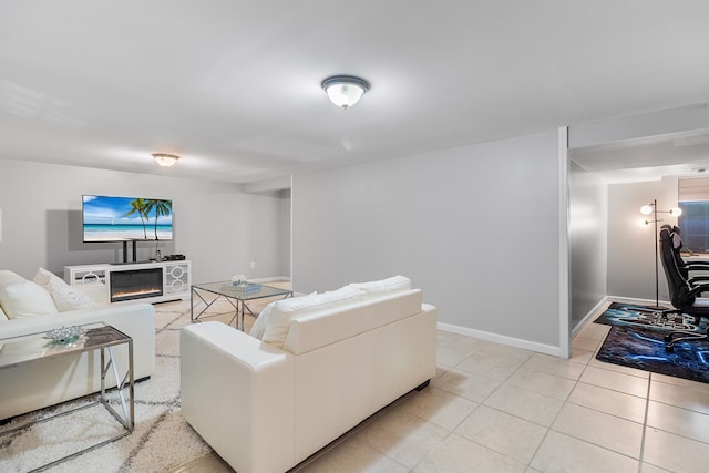 40 Ridge Haven Dr, Ridge, NY 11961 - living room featuring a glass covered fireplace and light tile patterned flooring