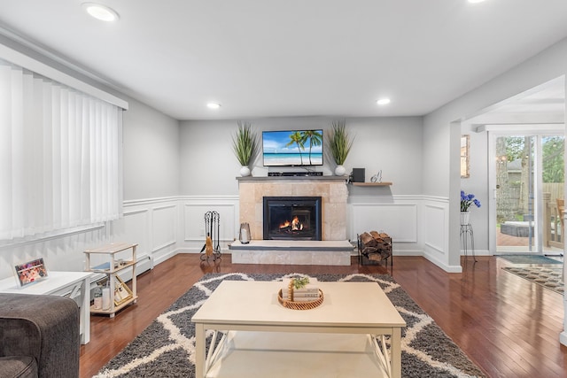 40 Ridge Haven Dr, Ridge, NY 11961 - living area featuring a tiled fireplace, wainscoting, a decorative wall, wood finished floors, and recessed lighting