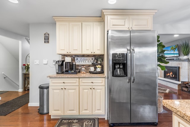 40 Ridge Haven Dr, Ridge, NY 11961 - kitchen featuring stainless steel fridge, cream cabinetry, dark wood-style floors, light stone counters, and decorative backsplash