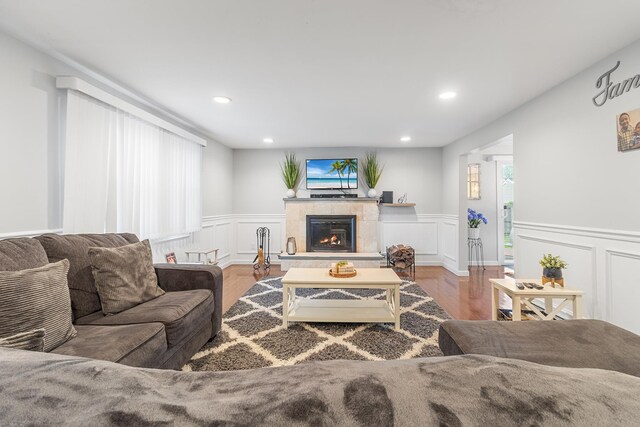 40 Ridge Haven Dr, Ridge, NY 11961 - living area featuring wood finished floors, wainscoting, recessed lighting, a fireplace, and a decorative wall