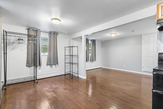 40 Ridge Haven Dr, Ridge, NY 11961 - unfurnished living room featuring wood finished floors and a baseboard heating unit