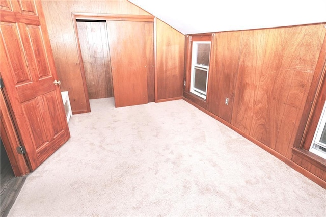 23 Kemble Ave, Cold Spring, NY 10516 - unfurnished bedroom with vaulted ceiling, carpet flooring, a closet, and wood walls