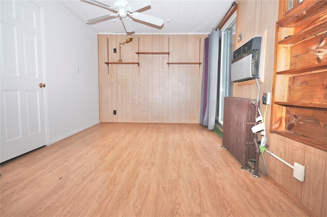 23 Kemble Ave, Cold Spring, NY 10516 - unfurnished room with ceiling fan, radiator heating unit, light wood finished floors, wood walls, and a wall unit AC