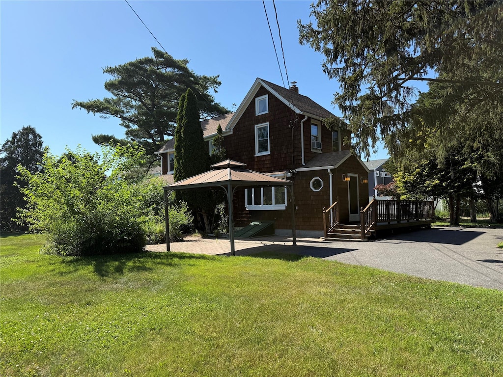 24 Bokel Rd, Ronkonkoma, NY 11779 - view of front of house featuring a wooden deck, a front lawn, and a gazebo