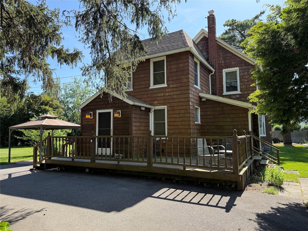 24 Bokel Rd, Ronkonkoma, NY 11779 - view of front of home featuring a chimney, a gazebo, a shingled roof, a wooden deck, and a front yard
