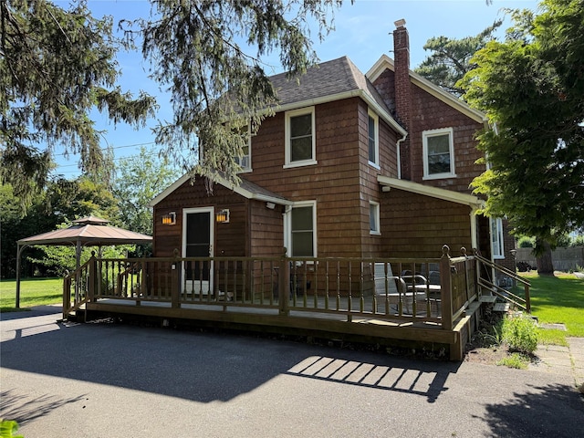 24 Bokel Rd, Ronkonkoma, NY 11779 - view of front of home featuring a chimney, a gazebo, a shingled roof, a wooden deck, and a front yard