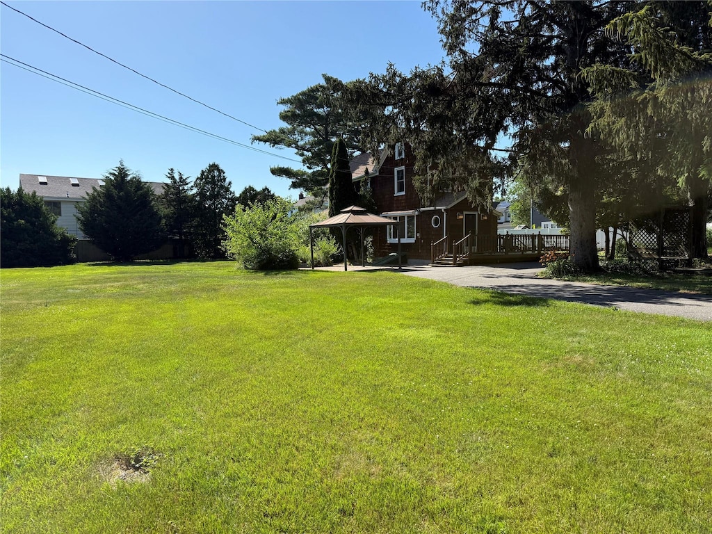 24 Bokel Rd, Ronkonkoma, NY 11779 - view of green lawn with a deck