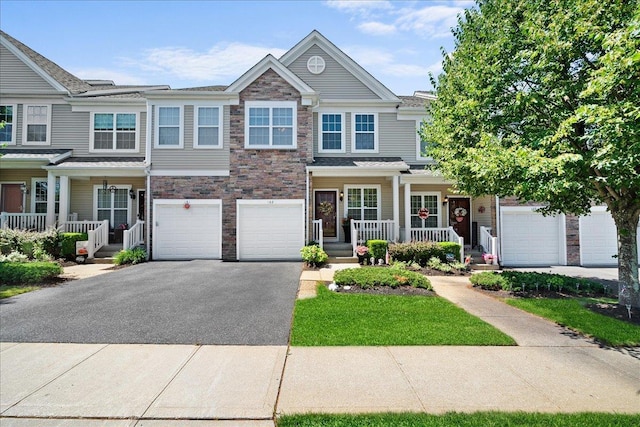 102 Paget Ln, Massapequa, NY 11758 - view of property with a porch, driveway, a garage, and stone siding