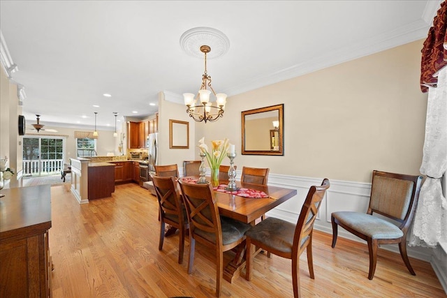 102 Paget Ln, Massapequa, NY 11758 - dining area featuring light wood-style flooring, a chandelier, crown molding, wainscoting, and recessed lighting