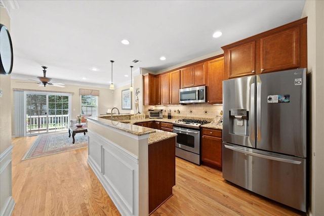 102 Paget Ln, Massapequa, NY 11758 - kitchen featuring stainless steel appliances, a peninsula, brown cabinetry, light wood-style floors, and backsplash