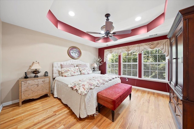 102 Paget Ln, Massapequa, NY 11758 - bedroom with a raised ceiling, light wood-style flooring, ceiling fan, and recessed lighting