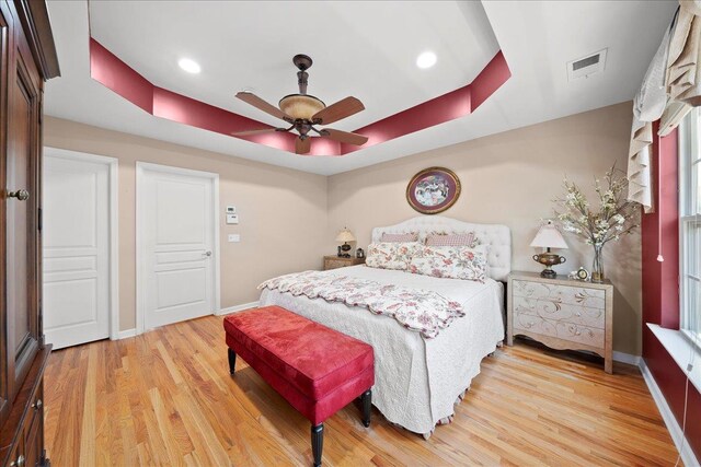 102 Paget Ln, Massapequa, NY 11758 - bedroom with a raised ceiling, light wood finished floors, ceiling fan, and recessed lighting