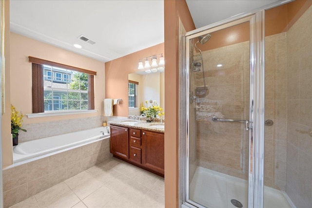 102 Paget Ln, Massapequa, NY 11758 - full bathroom featuring double vanity, a stall shower, a garden tub, and tile patterned flooring