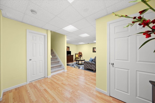102 Paget Ln, Massapequa, NY 11758 - foyer entrance featuring a drop ceiling, wood finished floors, and stairs