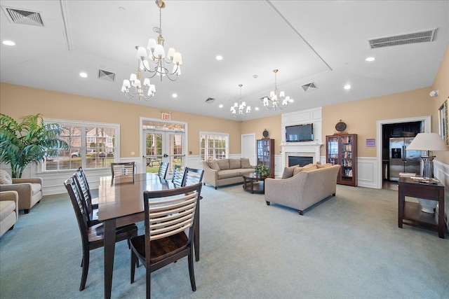 102 Paget Ln, Massapequa, NY 11758 - dining space with carpet flooring, a chandelier, a decorative wall, recessed lighting, and a wainscoted wall