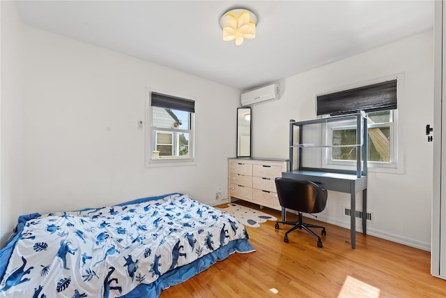 2354 128th St, College Point, NY 11356 - bedroom with an AC wall unit and wood finished floors