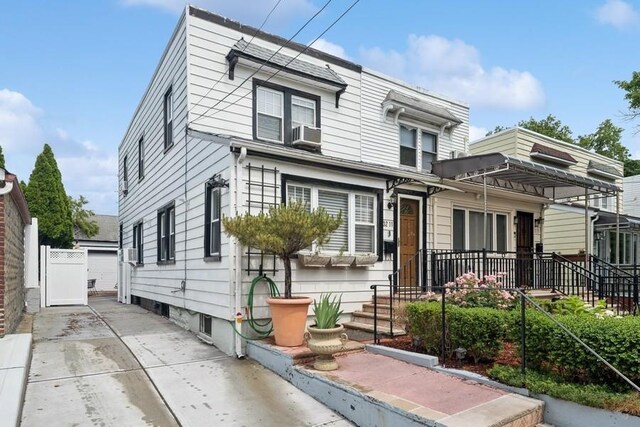 3211 204th St, Bayside, NY 11361 - townhome / multi-family property with cooling unit and a garage