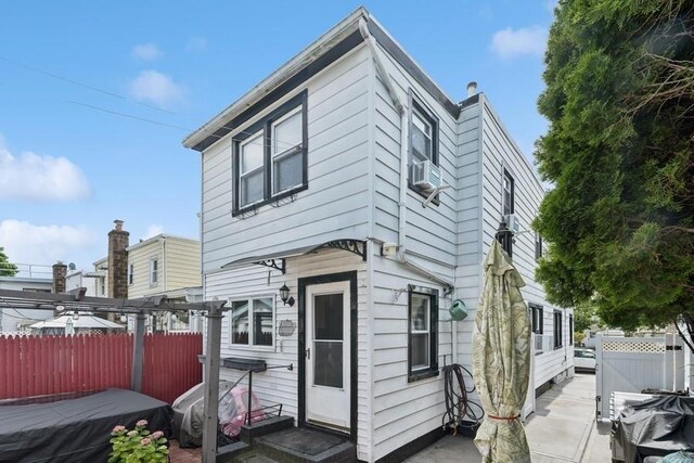 3211 204th St, Bayside, NY 11361 - rear view of property featuring cooling unit, entry steps, and a patio