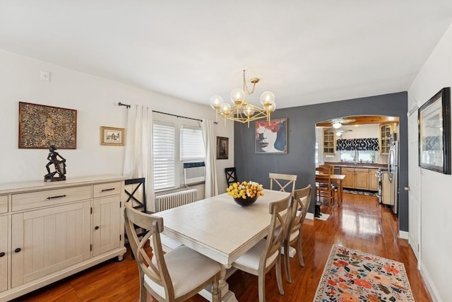 3211 204th St, Bayside, NY 11361 - dining area with arched walkways, radiator, dark wood finished floors, and plenty of natural light