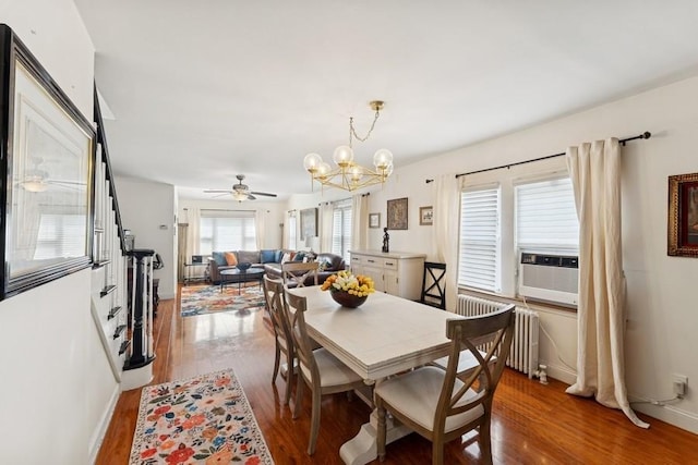 3211 204th St, Bayside, NY 11361 - dining space featuring radiator heating unit, wood finished floors, a chandelier, and ceiling fan