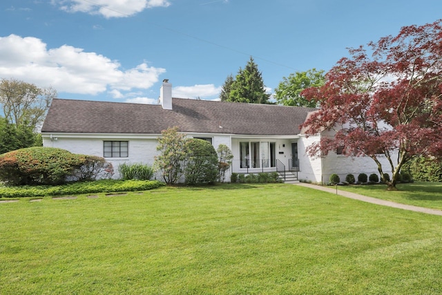 187 Thornbury Rd, Scarsdale, NY 10583 - view of front of home featuring a front yard, a chimney, and roof with shingles