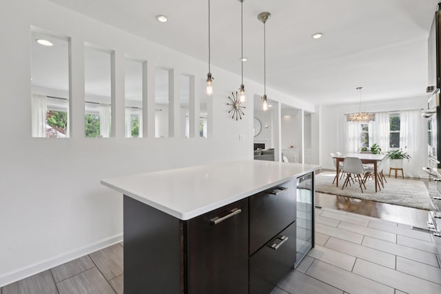 187 Thornbury Rd, Scarsdale, NY 10583 - kitchen featuring light countertops, modern cabinets, beverage cooler, a center island, and pendant lighting