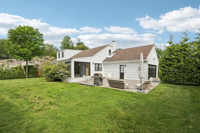 187 Thornbury Rd, Scarsdale, NY 10583 - rear view of property with a garage, a patio area, a lawn, outdoor lounge area, and a chimney