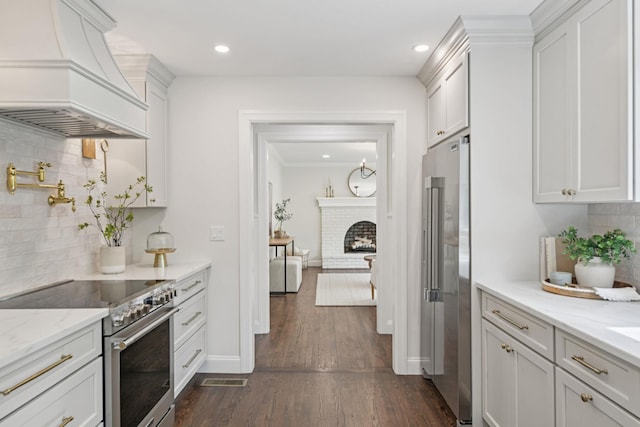 131 Long Pond Rd, Wading River, NY 11792 - kitchen featuring premium appliances, custom exhaust hood, backsplash, white cabinets, and dark wood-type flooring