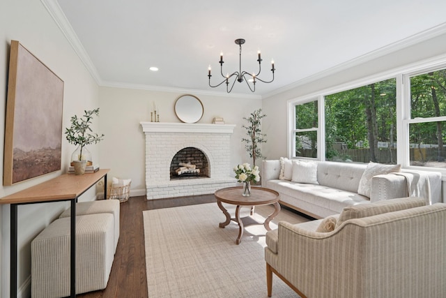 131 Long Pond Rd, Wading River, NY 11792 - living room with healthy amount of natural light, a chandelier, crown molding, wood finished floors, and a brick fireplace