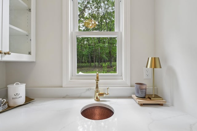 131 Long Pond Rd, Wading River, NY 11792 - kitchen view of light stone counters, glass insert cabinets, and white cabinetry