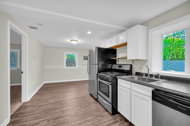 23 White Oak Ln, Bardonia, NY 10954 - kitchen featuring appliances with stainless steel finishes, dark countertops, white cabinets, wood finished floors, and recessed lighting