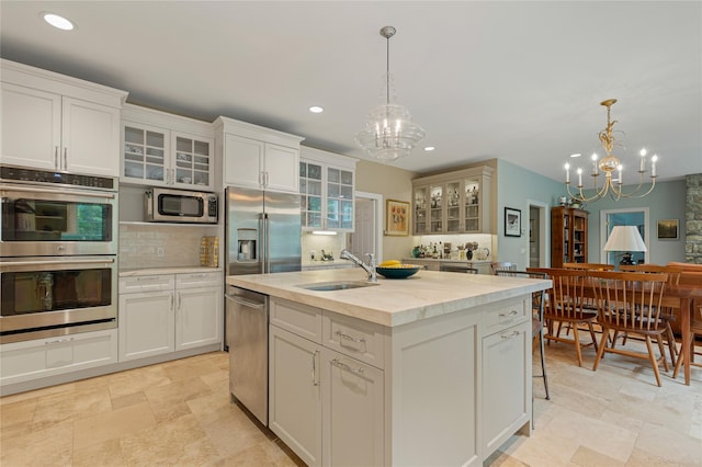 4 Hidden Valley Way, Bedford, NY 10506 - kitchen featuring a chandelier, stainless steel appliances, recessed lighting, light stone finish flooring, and decorative backsplash