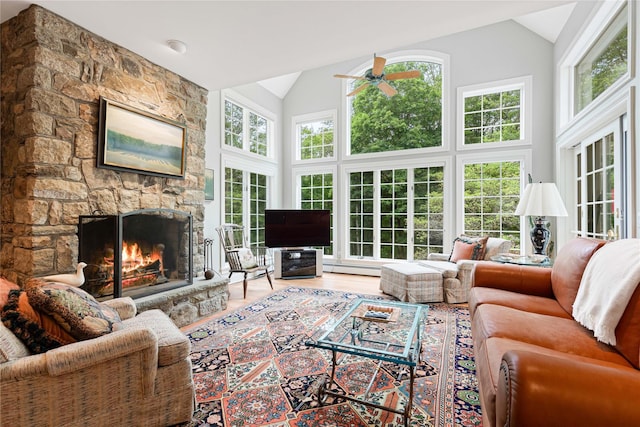 4 Hidden Valley Way, Bedford, NY 10506 - living room featuring a ceiling fan, a stone fireplace, high vaulted ceiling, wood finished floors, and a baseboard radiator