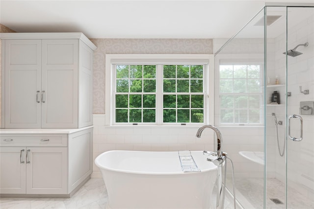 4 Hidden Valley Way, Bedford, NY 10506 - bathroom featuring a shower stall, a freestanding tub, marble finish floors, wallpapered walls, and tile walls
